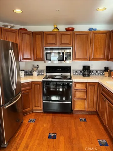 a kitchen with a sink a stove and cabinets