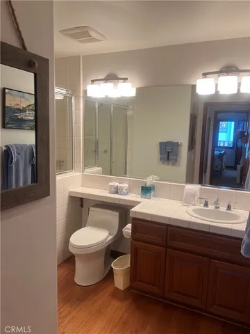 a bathroom with a double vanity sink toilet and a mirror