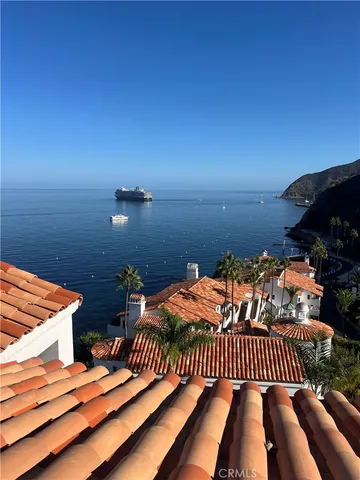 a balcony with lamp on dining table and chairs
