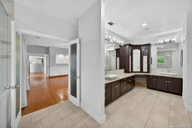 a large bathroom with a large tub and sink