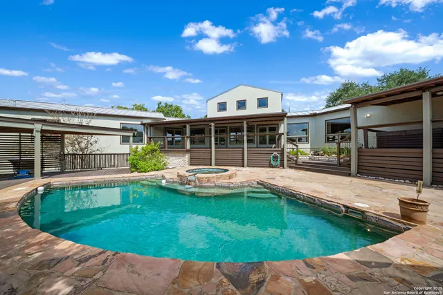 a view of an house with swimming pool and porch