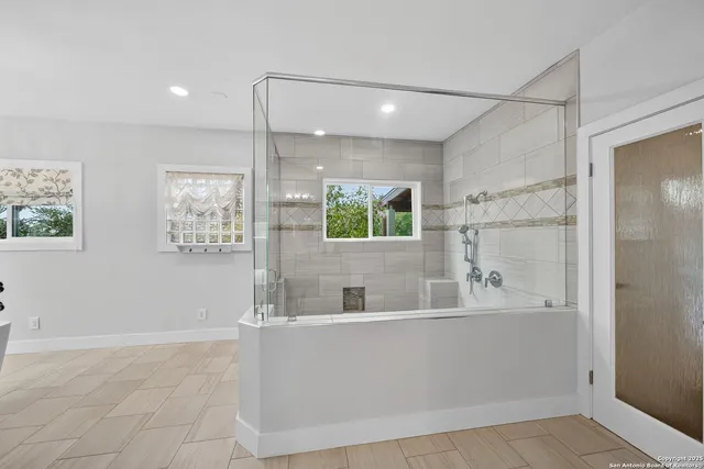 a bathroom with a bathtub and a shower