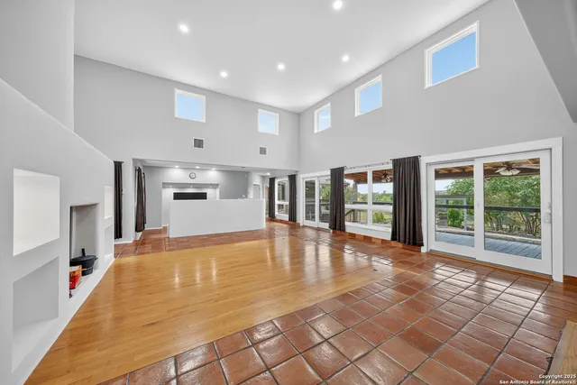 a view of a living room with kitchen view and a large window
