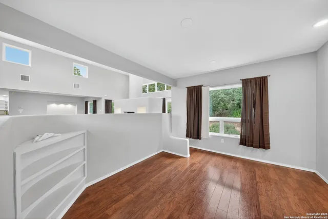 a view of a kitchen with wooden floor and electronic appliances