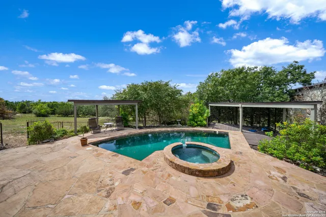 a swimming pool with outdoor seating and garden