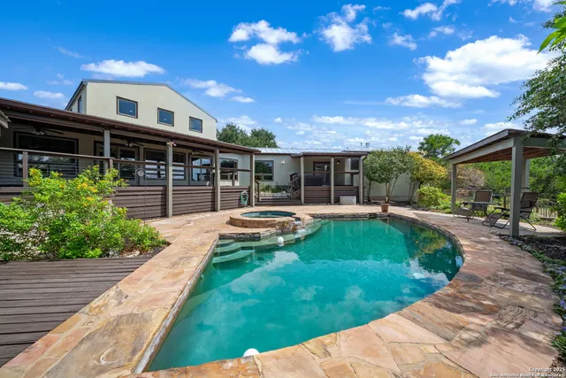 a view of a house with swimming pool and sitting area