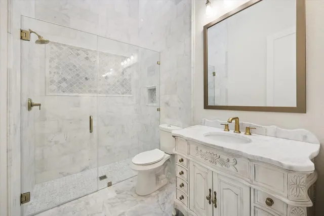 a spacious bathroom with a double vanity sink mirror and toilet