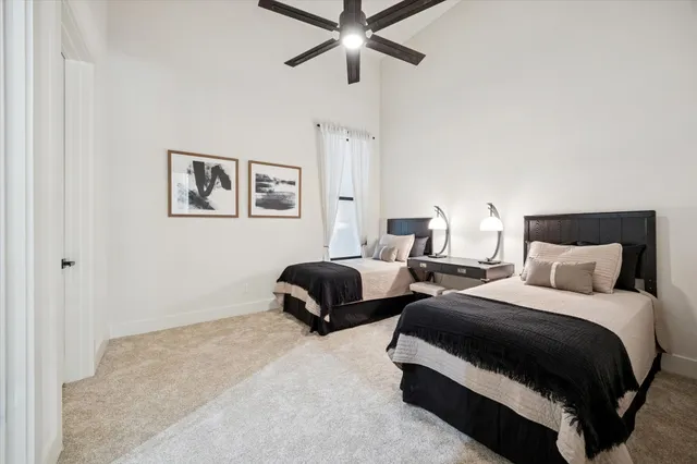 a spacious bedroom with a bed and a window