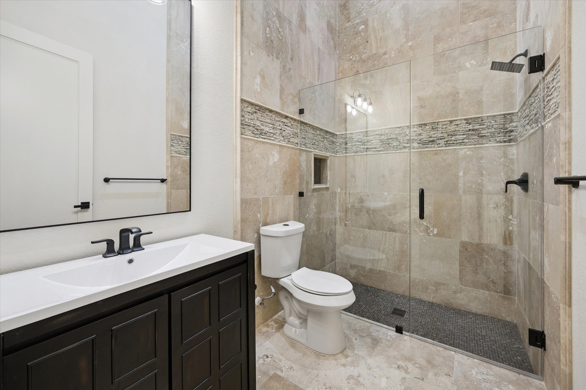 11 River Circle Houston, TX 77063 - Photo 24 of 34 a bathroom with a sink a toilet and shower