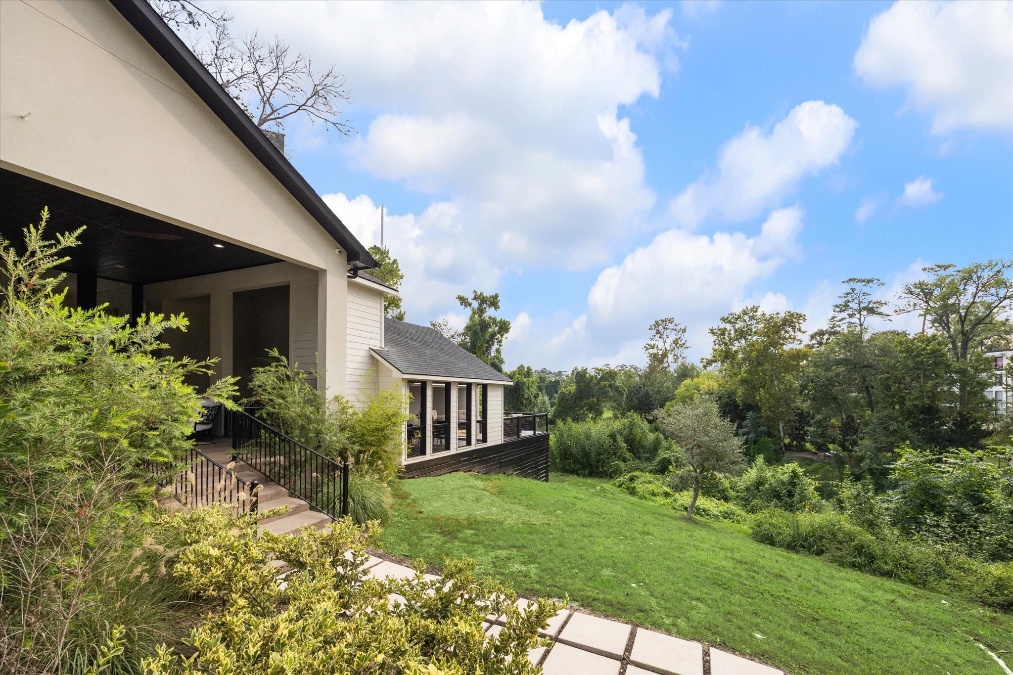 11 River Circle Houston, TX 77063 - Photo 25 of 34 a view of a house with brick walls and a yard with potted plants