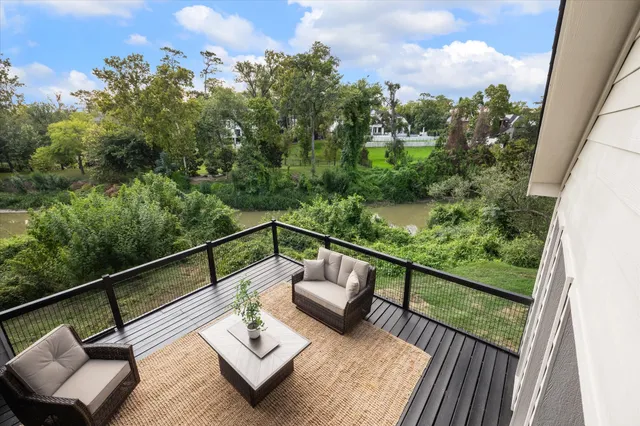a view of a house with brick walls and a yard with potted plants