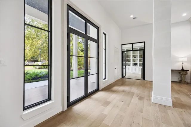 a dining room with furniture window and wooden floor