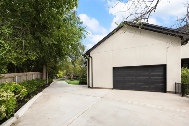 a roof deck with couches and potted plants
