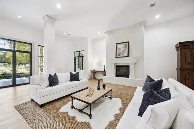 a view of a big room with wooden floor and windows