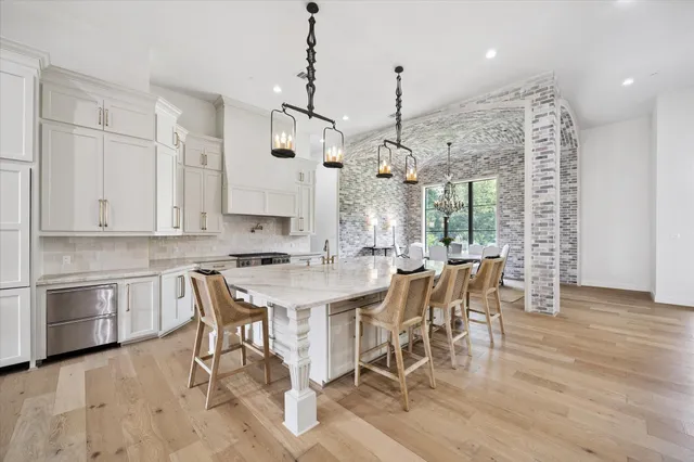 a living room with furniture white walls and a large window