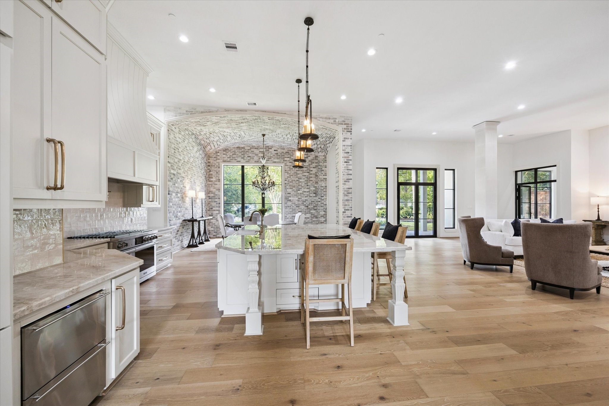 11 River Circle Houston, TX 77063 - Photo 7 of 34 a kitchen with stainless steel appliances granite countertop sink stove and white cabinets with wooden floor