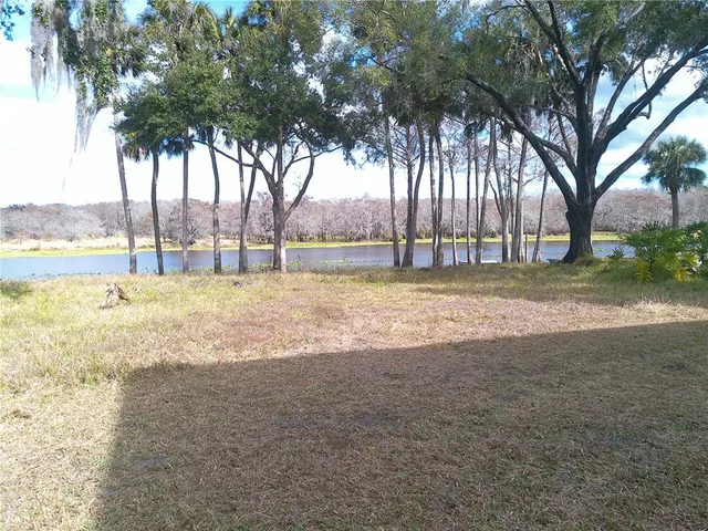 a swimming pool with an outdoor space and seating area