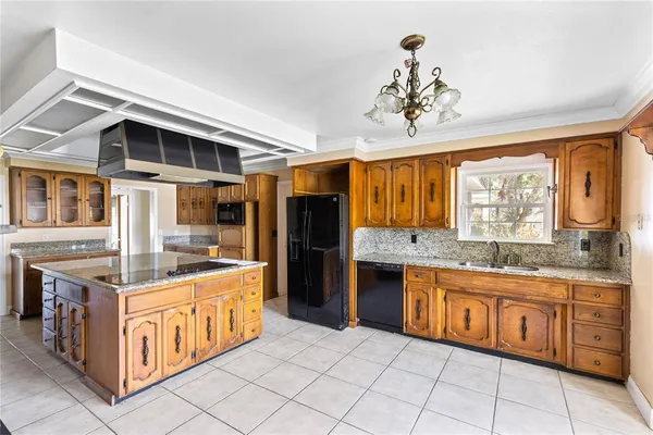 a kitchen with stainless steel appliances granite countertop a stove and cabinets