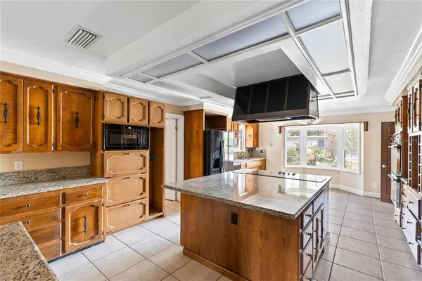 a kitchen with stainless steel appliances granite countertop a sink and cabinets