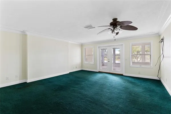 a view of room with hardwood floor and ceiling fan