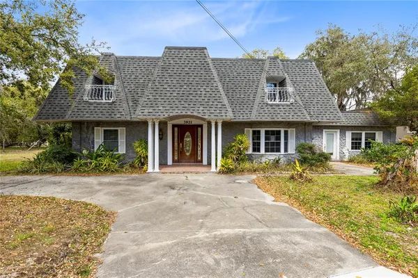 a front view of a house with garden and porch
