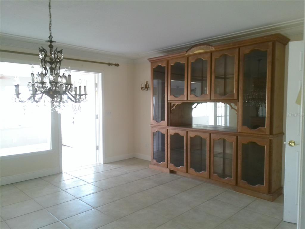 3821 East Osceola Road Geneva, FL 32732 - Photo 22 of 37 a view of a livingroom with kitchen and chandelier