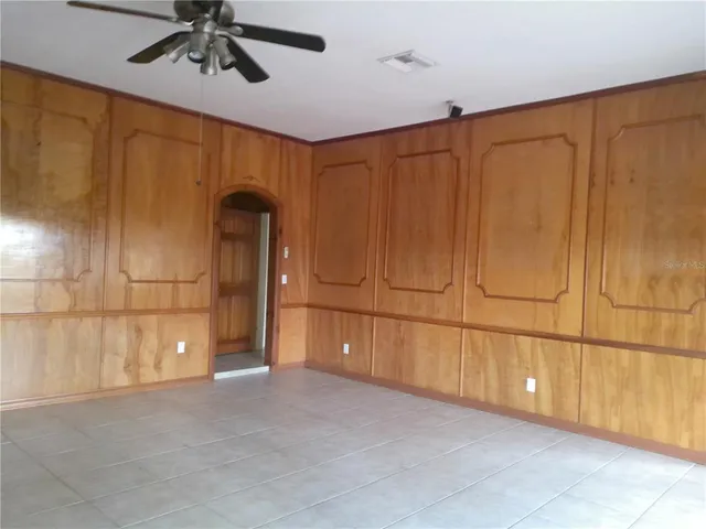 a view of room with a ceiling fan and window