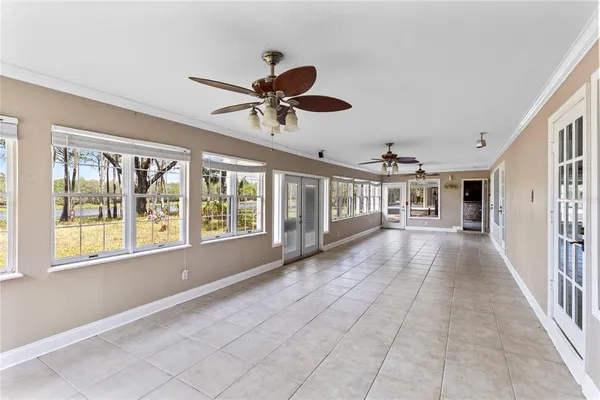 a view of a livingroom with a ceiling fan and window