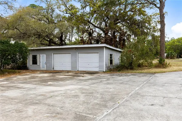 a backyard of a house with large trees