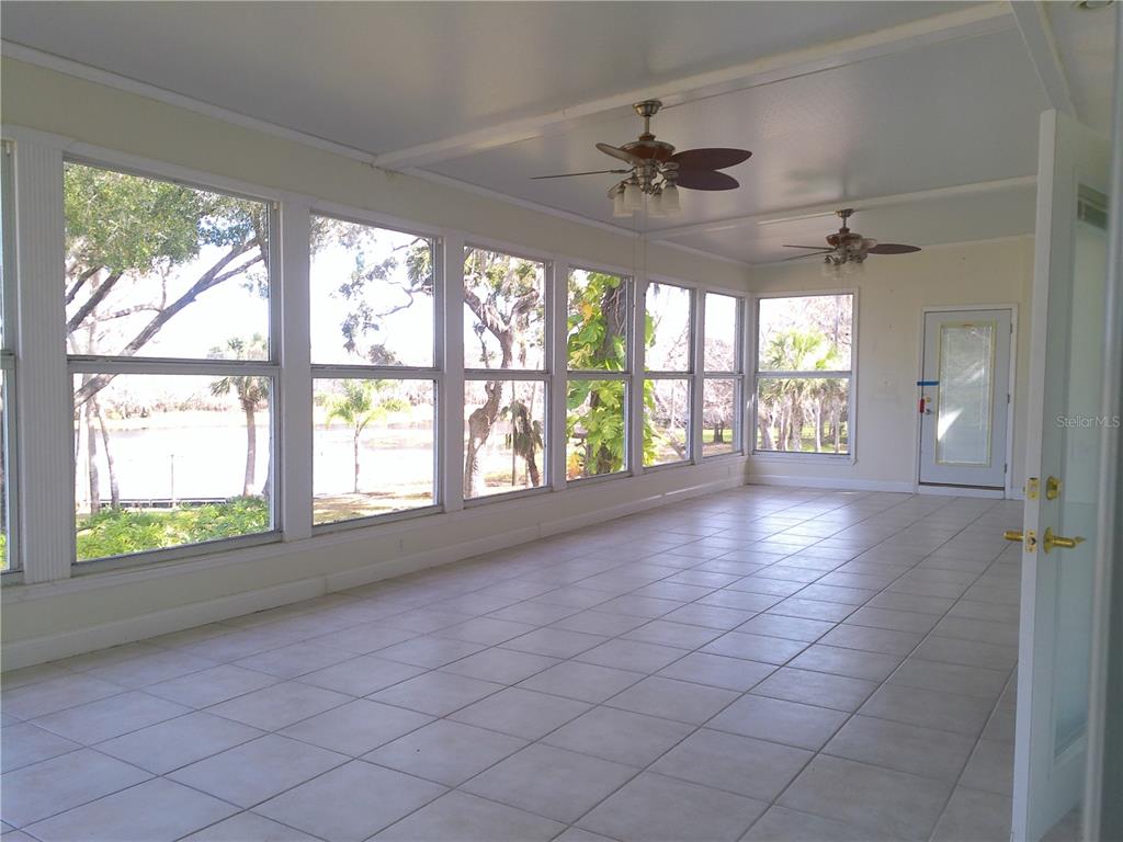 3821 East Osceola Road Geneva, FL 32732 - Photo 31 of 37 an empty room with windows and chandelier fan
