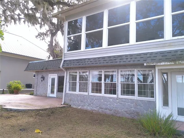 a front view of a house with a yard and parking space