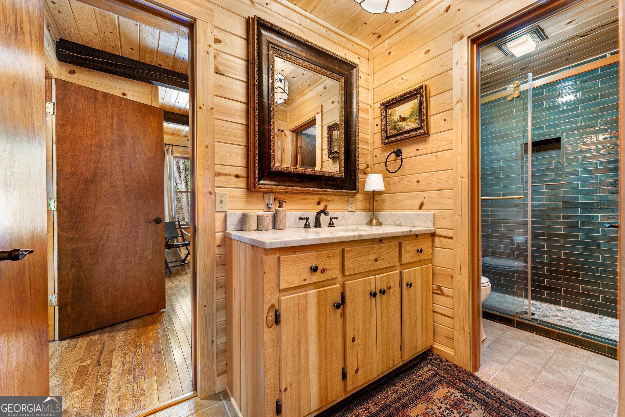 310 Blue Ridge Drive Sautee Nacoochee, GA 30571 - Photo 24 of 78 a bathroom with a sink a mirror and next to a window