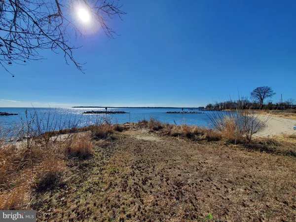 a view of a lake with a table and chairs