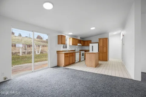 a kitchen with refrigerator and window