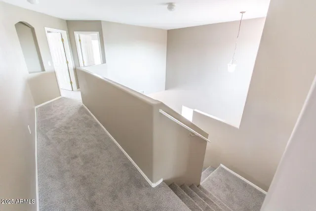 a view of hallway with wooden floor