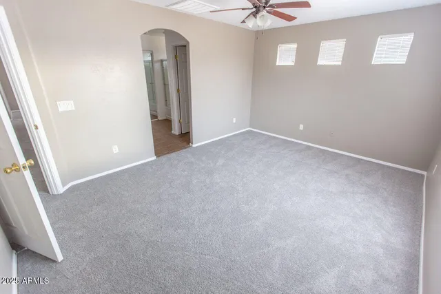 an empty room with windows and closet