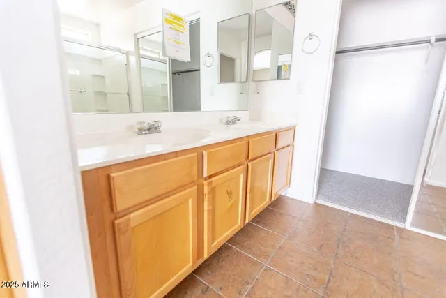 a bathroom with a sink a mirror and a shower