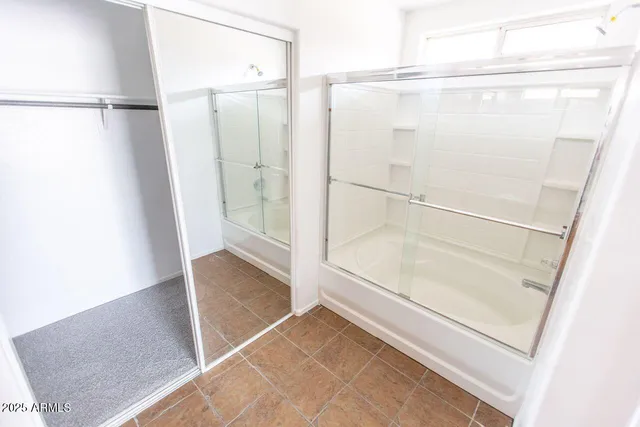 a bathroom with a glass shower door