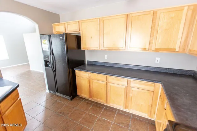 a bathroom with a granite countertop sink and a shower