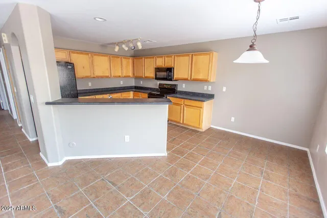 a kitchen with stainless steel appliances a stove a sink and a refrigerator