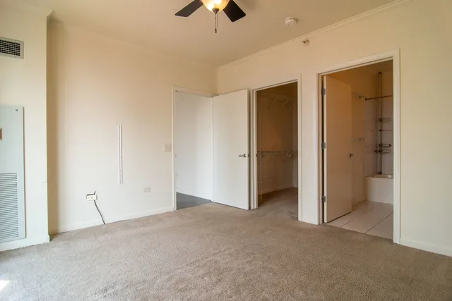 an empty room with chandelier fan