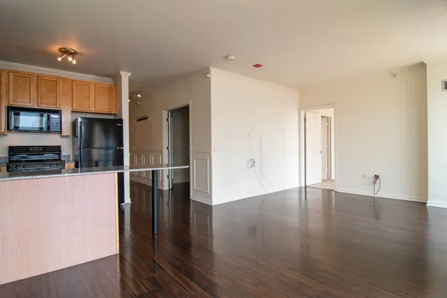 a view of a kitchen with wooden floor and a sink