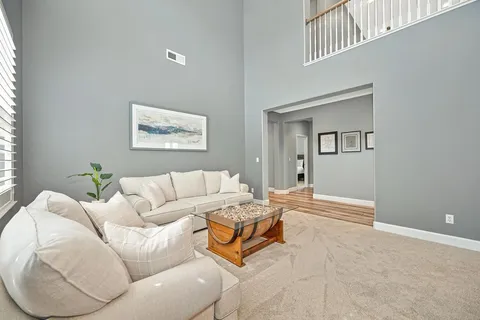 a living room with furniture and a chandelier