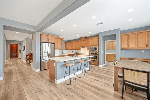 a kitchen with stainless steel appliances granite countertop a sink stove and cabinets