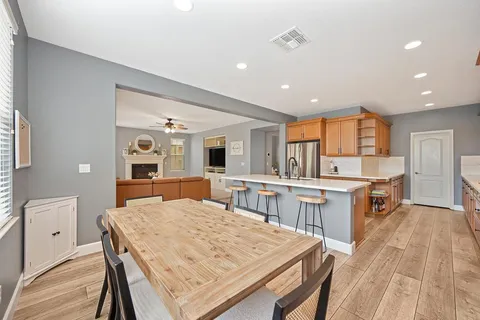 a dining room with a wooden table and chairs