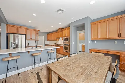 a kitchen with granite countertop cabinets stainless steel appliances a sink and a counter space