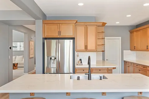 a kitchen with lots of counter top space and wooden floor