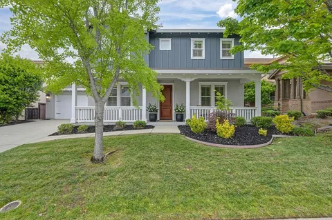 a front view of a house with a yard and porch