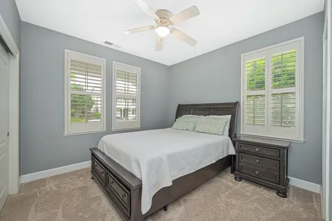 a bedroom with a bed and a desk