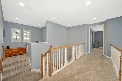 a view of a hallway with wooden floor and closet area
